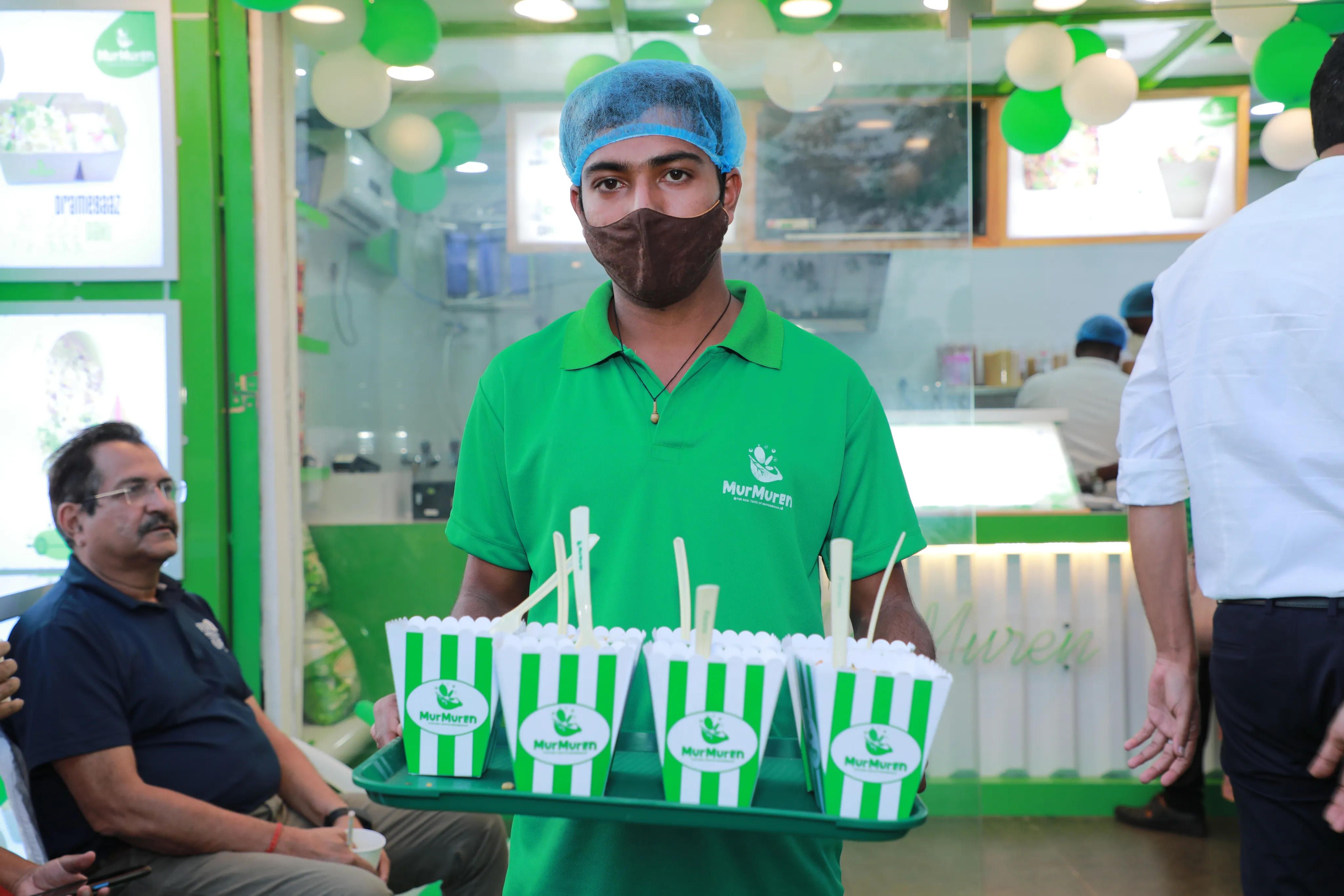 Staff holding Bhel cups